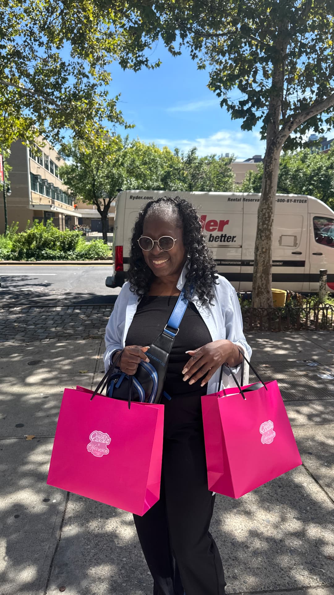 Attendee carrying two pink Her Voice Project bags